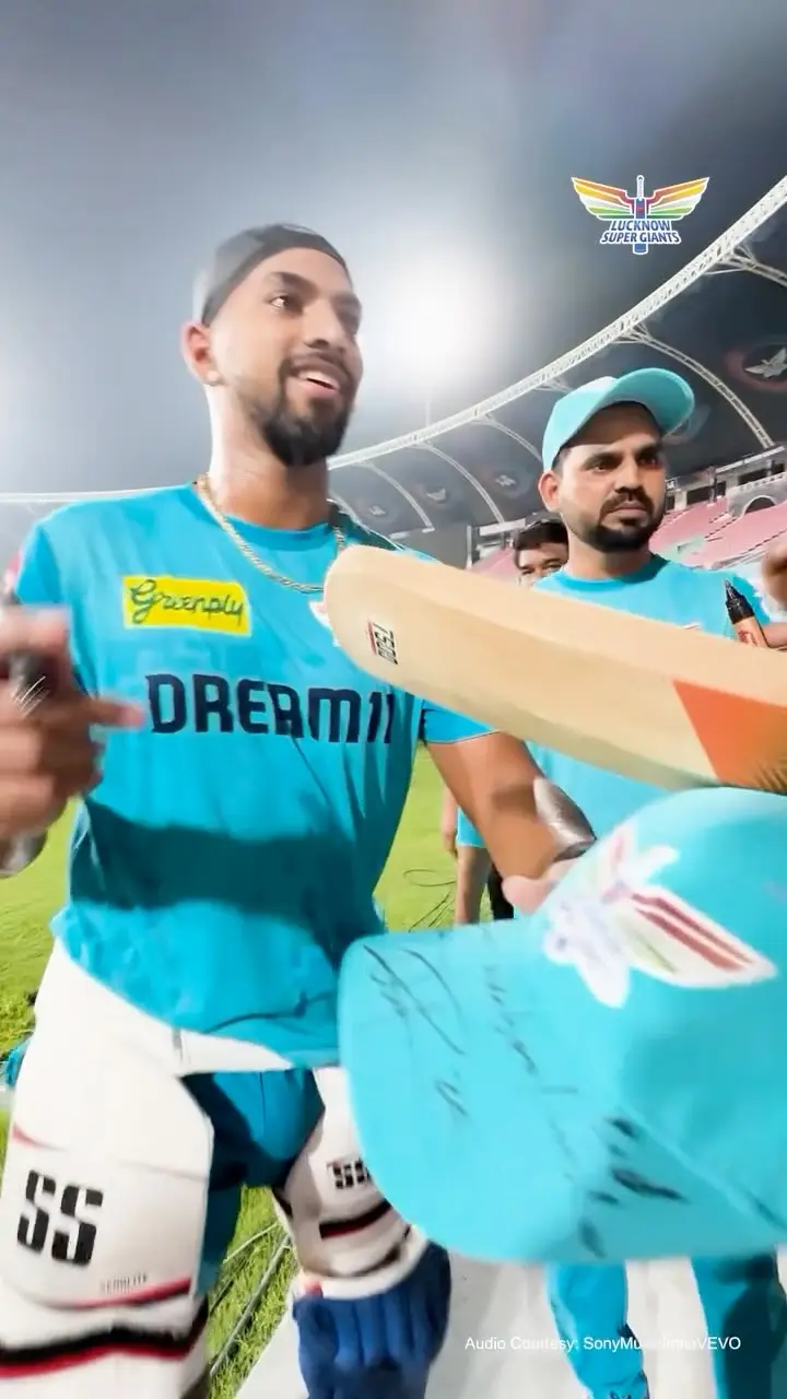West Indies batsman connects with the fan struck by his six during the match against Gujarat Titans.