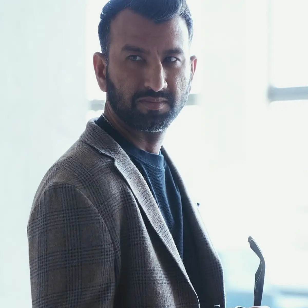 Captured Candid: Cheteshwar Pujara In A Genuine Moment A snapshot of India's veteran batsman reflects passion and a quiet off-field personality.
