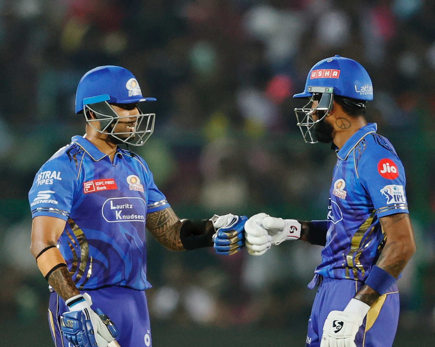 Players ignite team spirit, uniting force on cricket pitch amid roaring applause.
