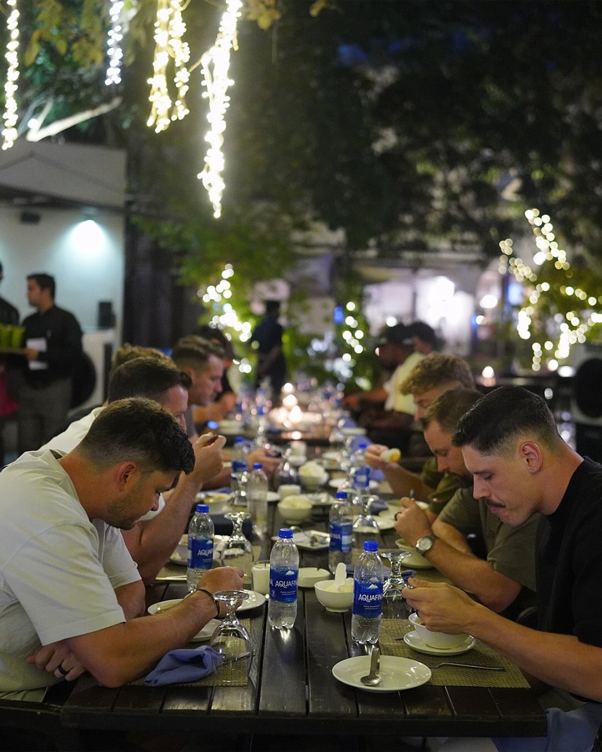 Team enjoys a vibrant dinner with heartfelt laughs, stories, and unity for all.